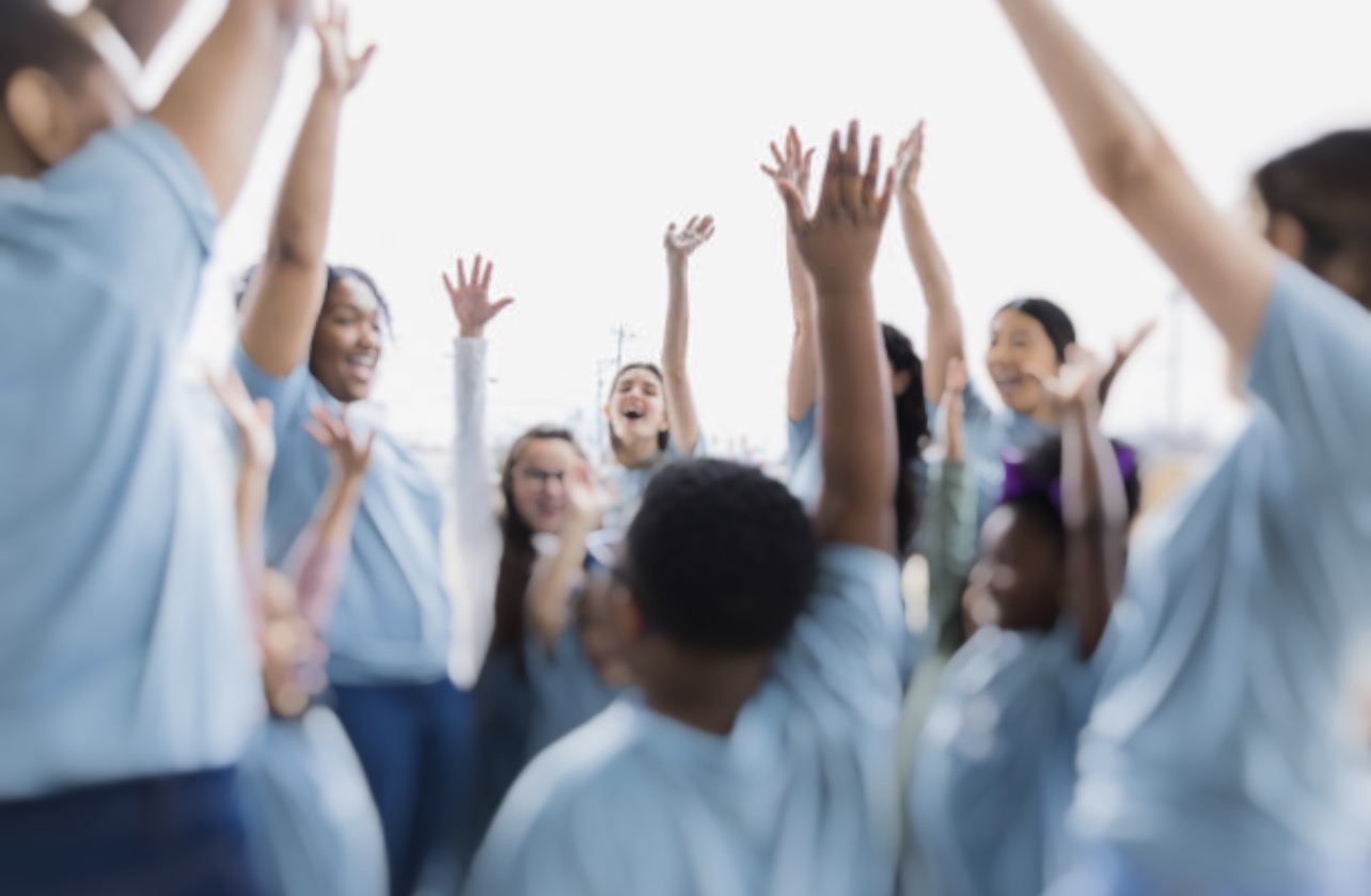 Children with hands raised